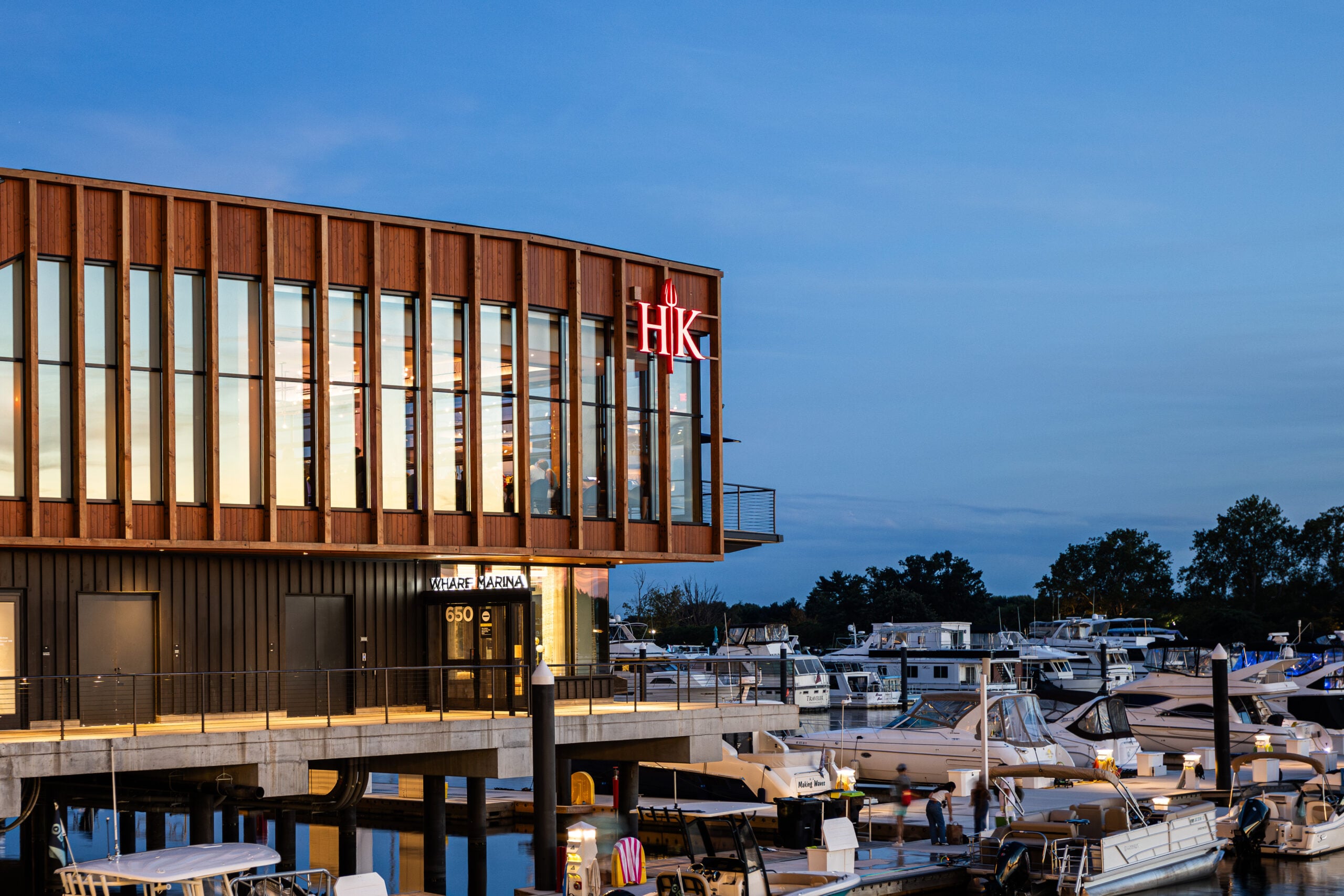 HK restaurant overlooking a marina at dusk.