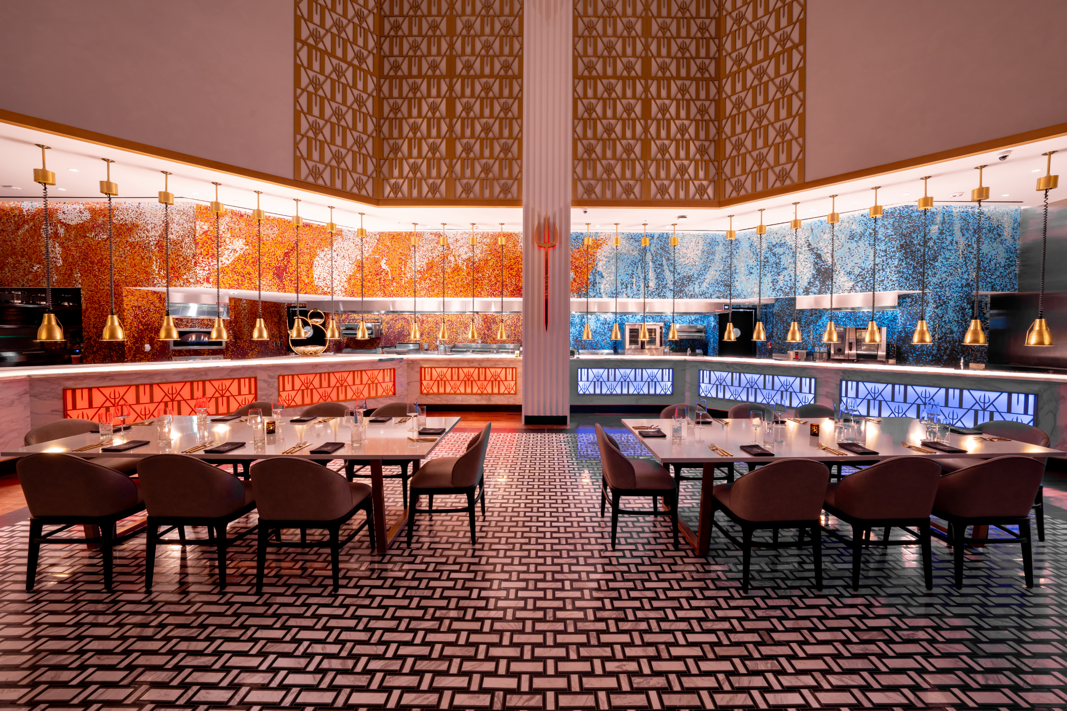 Symmetrical dining room with tables, chairs, and illuminated bar counters featuring mosaic walls.